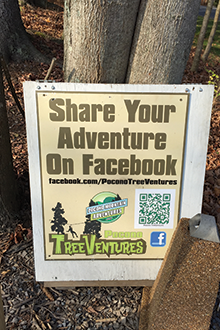 A promotional photo-sharing sign at TreeVentures increases guest sharing and word-of-mouth marketing for the park.